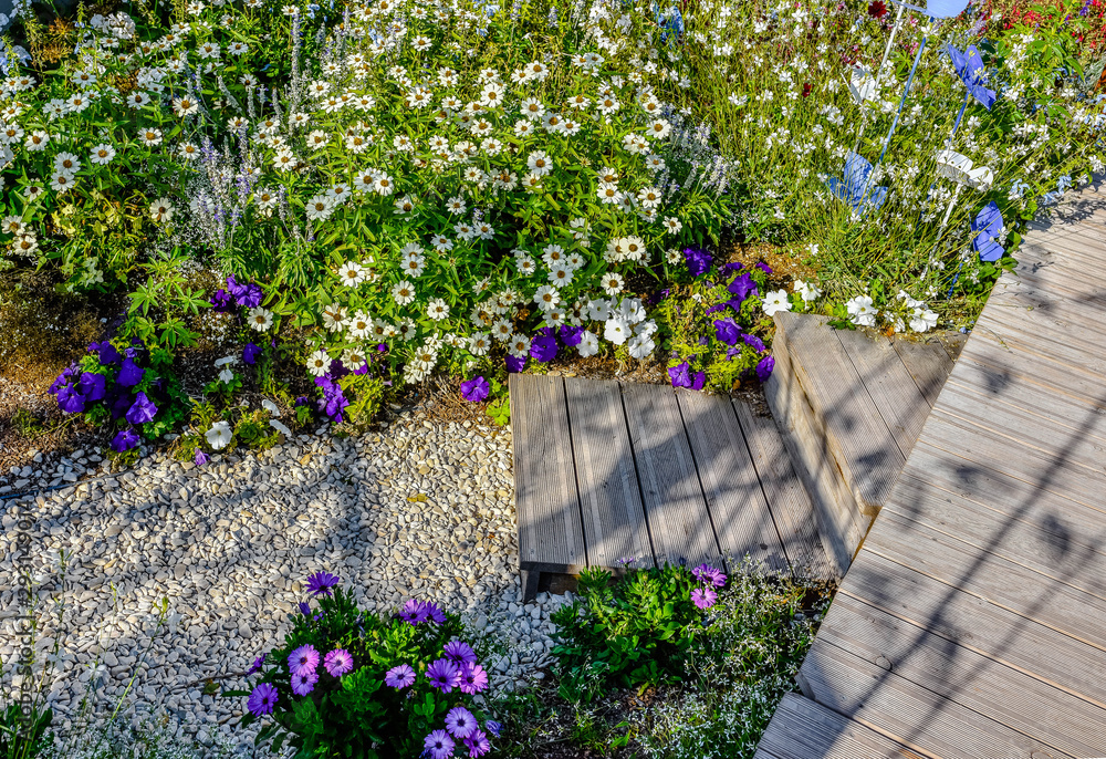 Fototapeta premium beautiful terrace and wooden driveway in the blooming garden