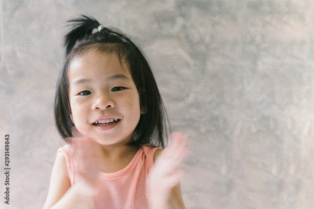 Close-Up Portrait Of Cute Girl Standing Against Wall Close-Up Portrait Of Cute Girl Standing Against Wall