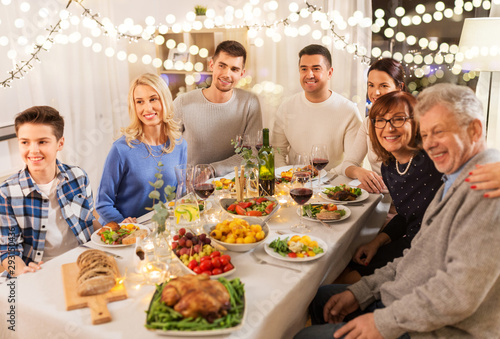 celebration, holidays and people concept - happy family having dinner party at home