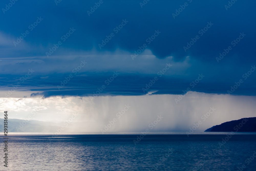 Wall of rain in a storm over the surface of lake Baikal