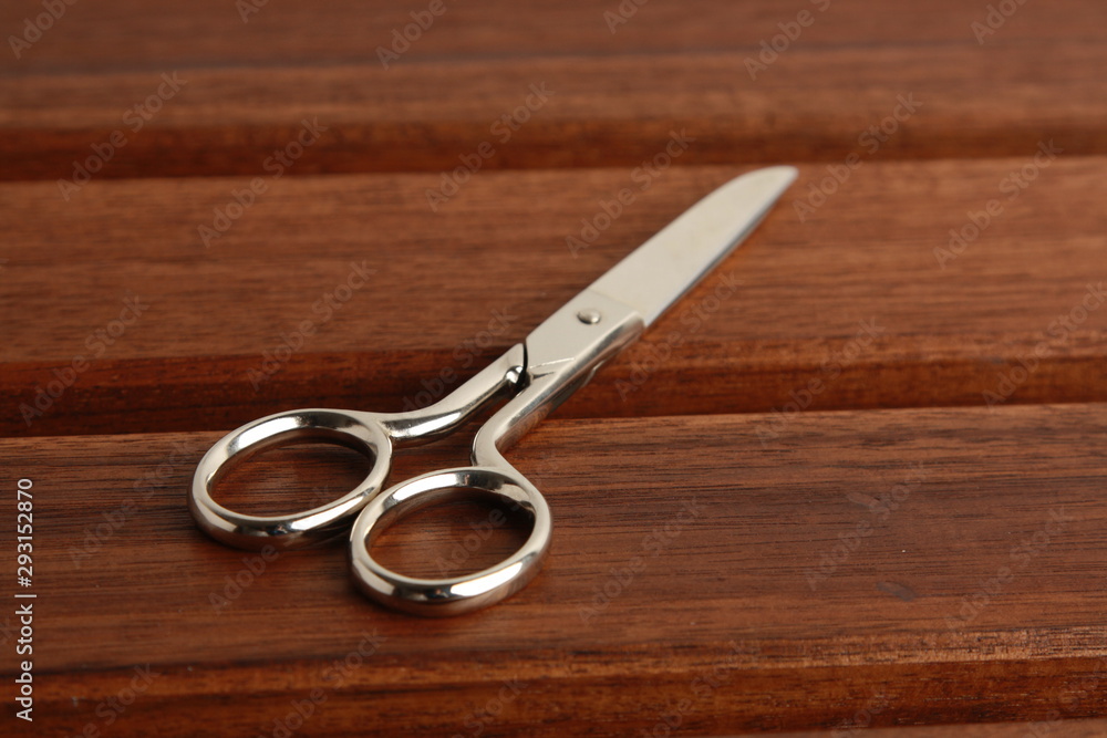 sewing scissors on wooden background