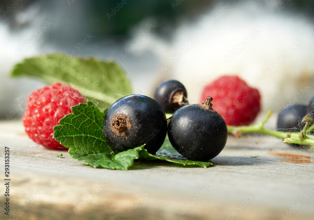 Fresh berries on wooden background. Raspberries and black currants. Fresh berries on wooden background. Raspberries and black currants.