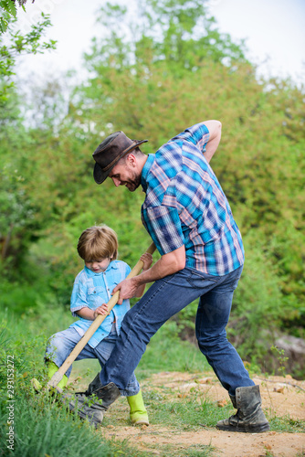 Find treasures. Little boy and father with shovel looking for treasures. Happy childhood. Adventure hunting for treasures. Little helper working in garden. Cute child in nature having fun with shovel