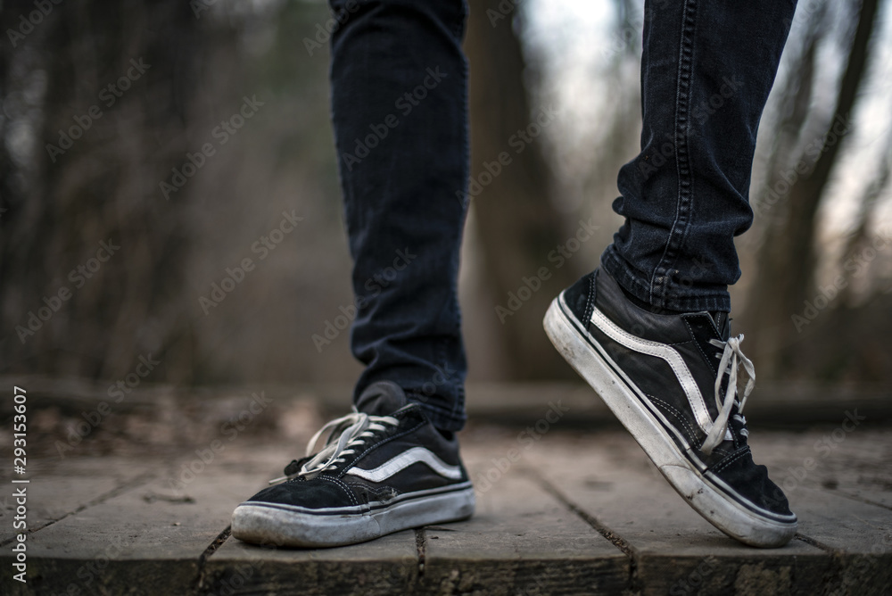 Young man Vans Old Skool shoes walking in the forest Stock Photo | Adobe Stock