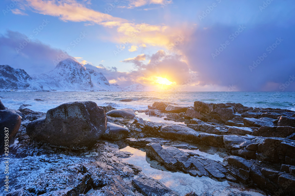 Coast of Norwegian sea on rocky coast in fjord on sunset