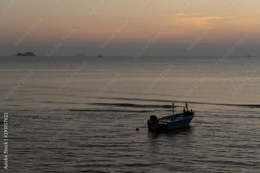 The beautiful landscape of fishing boat floating on sea with sunset blackground,thailand The beautiful landscape of fishing boat floating on sea with sunset blackground,thailand