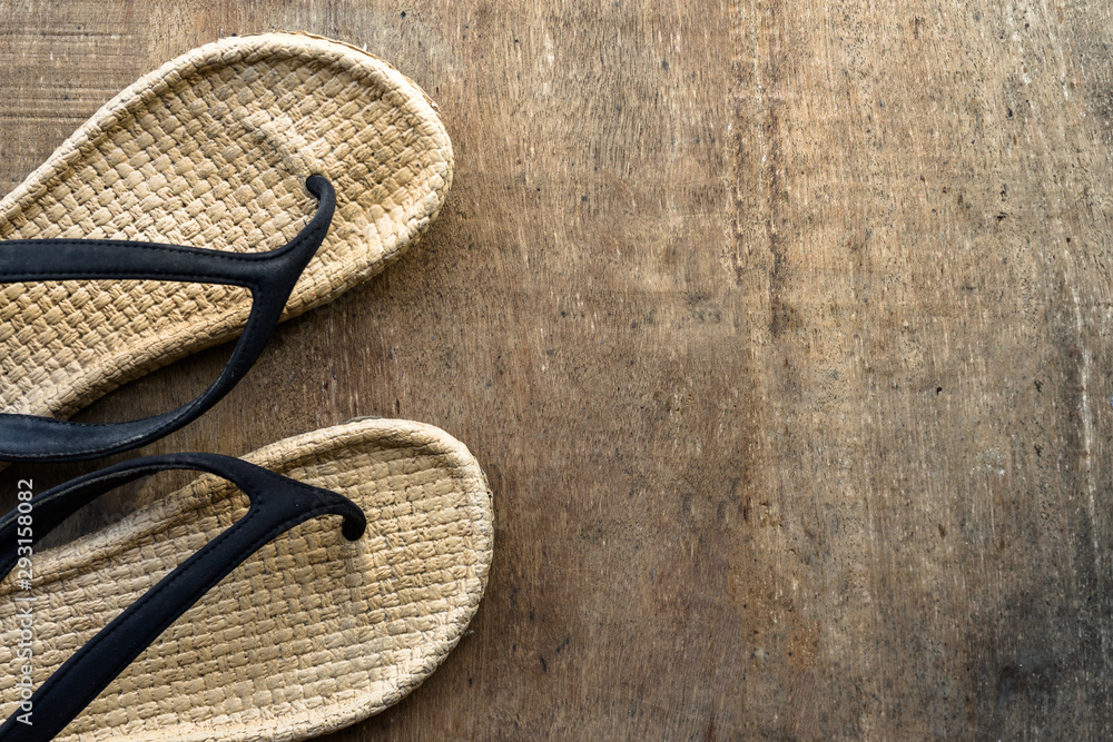 Vintage cosy sandal or slipper is placed on the wooden surface with