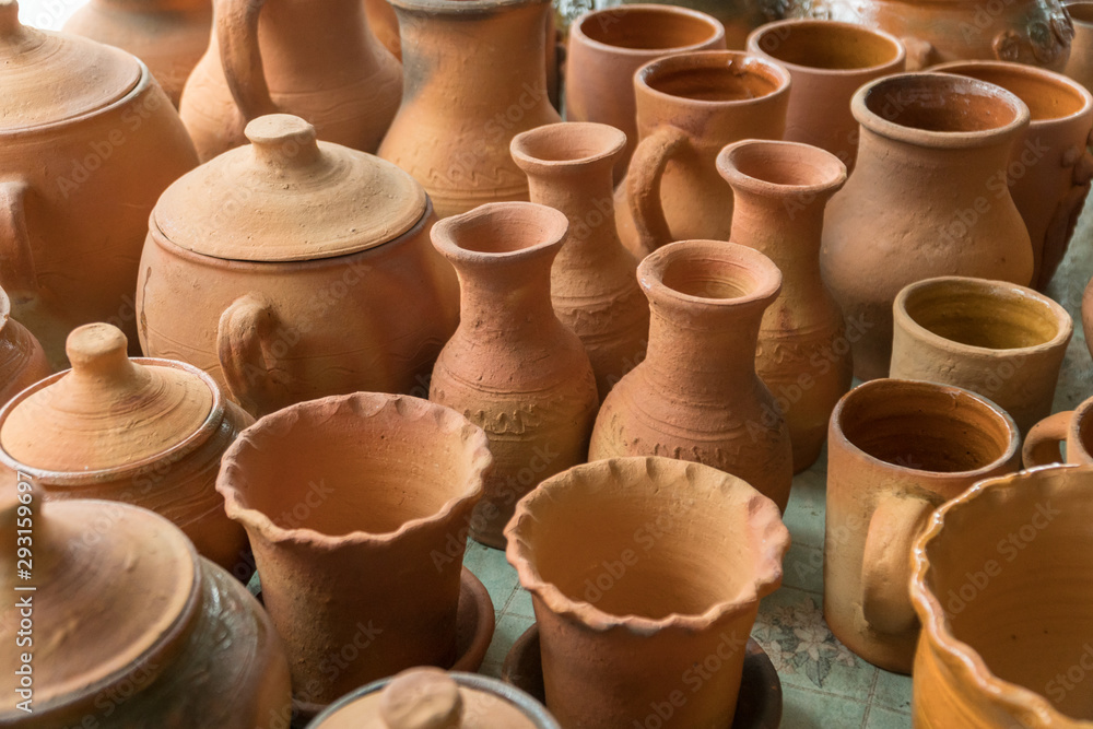 Brown clay pots made in ground oven with firewoods using old traditional  ukrainian pottery technology. Stock Photo