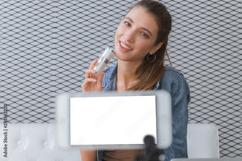 Beautiful women vlogger live video on mobile smartphone. Glamour girl holding cosmetic products selling online. Beautiful women vlogger live video on mobile smartphone. Glamour girl holding cosmetic products selling online.