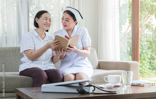Caregiver with elderly of kindness concept. Nurses and elderly read book and happy.