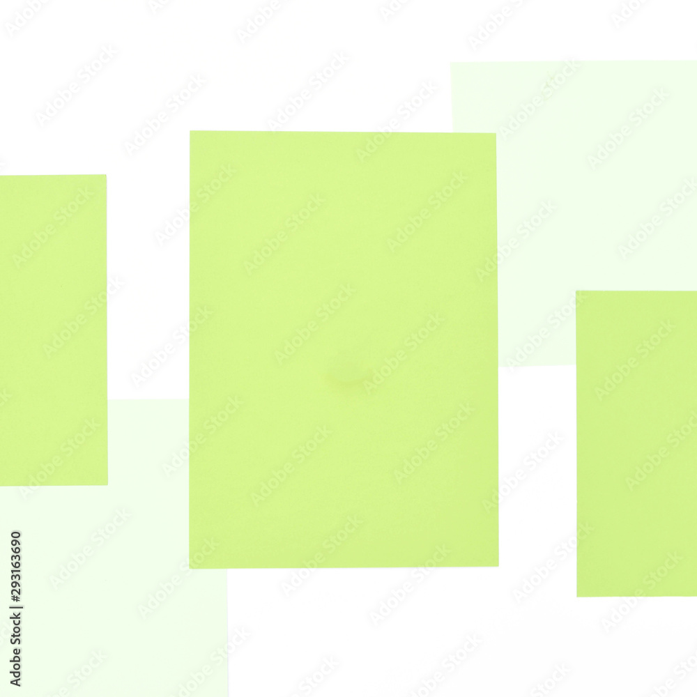 Light background with isolated white and green sheets of paper.
