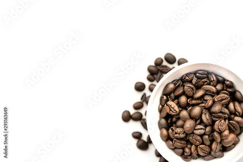 Coffee beans in white coffee cup isolated on white table desk with workspace. Copy space empty blank for text.Time to drink.