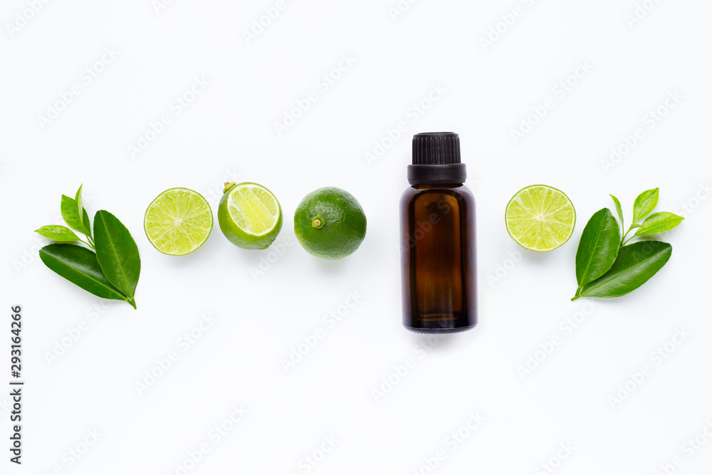 Essential oil with Limes and leaves isolated on white. Essential oil with Limes and leaves isolated on white.