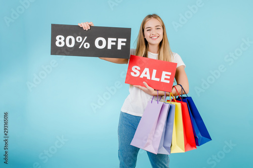 happy smiling woman with 80% off sale sign and colorful shopping bags isolated over blue