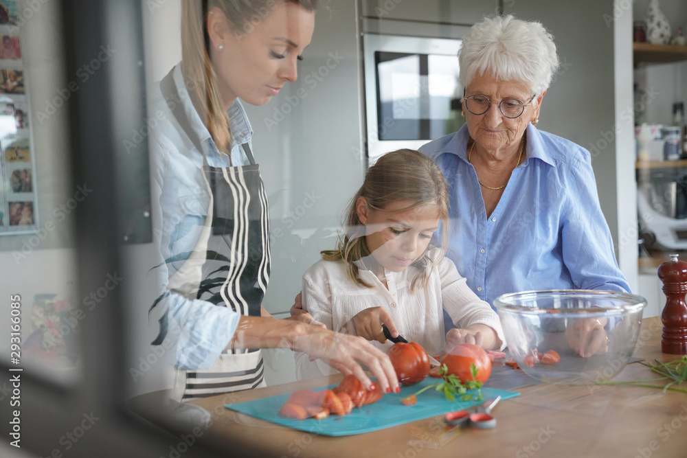 Obraz premium 3-generation-family cooking together