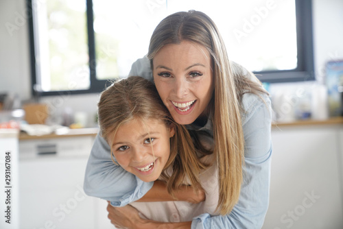 Portrait of cheerful mother and daughter
