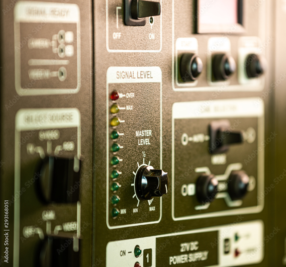 Fototapeta premium Close-up side view of panel of buttons and twirls