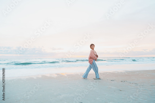 portrait of happy smiling young woman on the beach
