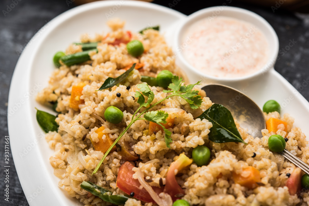 Broken wheat or Daliya Upma, served in a bowl. selective focus Broken wheat or Daliya Upma, served in a bowl. selective focus