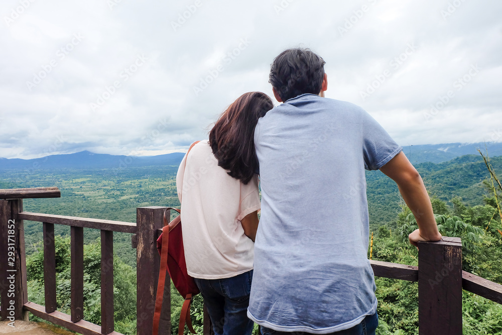 Asia couple hugging each other and nature, behind view
