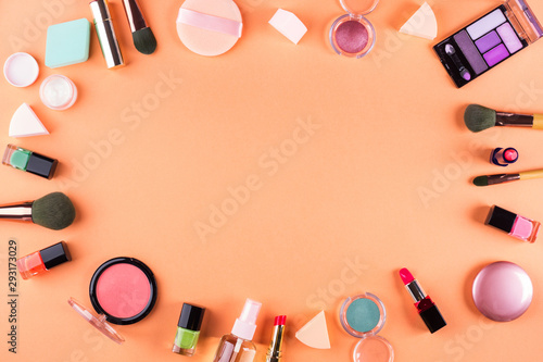 Make up accessories on orange cantaloupe background. Beauty products colorful fashion flat lay