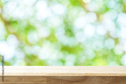 Empty white table and blurred garden bokeh background. mock up for display or montage of product  Business presentation.