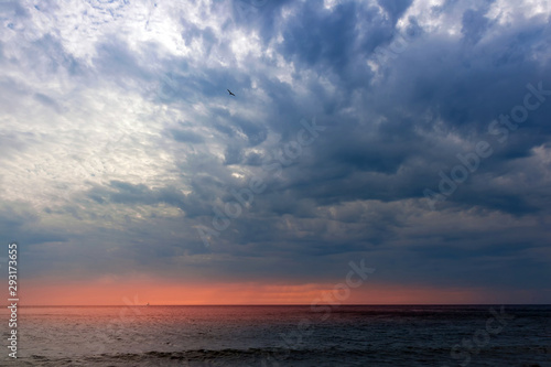 Dramatic sky and red sunset over the sea © Maxim B