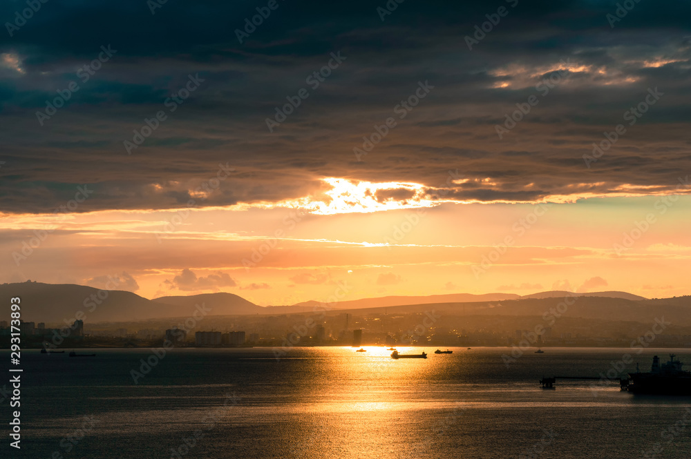 Sunset and evening bay with ships