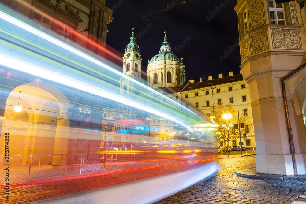 view on baroque church and night traffic in Prague, Czech republic