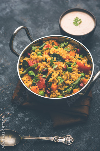 Broken wheat or Daliya Upma, served in a bowl. selective focus