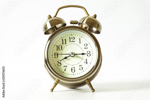 Alarm clock is placed on the desk in the morning with a white background. Time change concept, Saving time, Time is money.