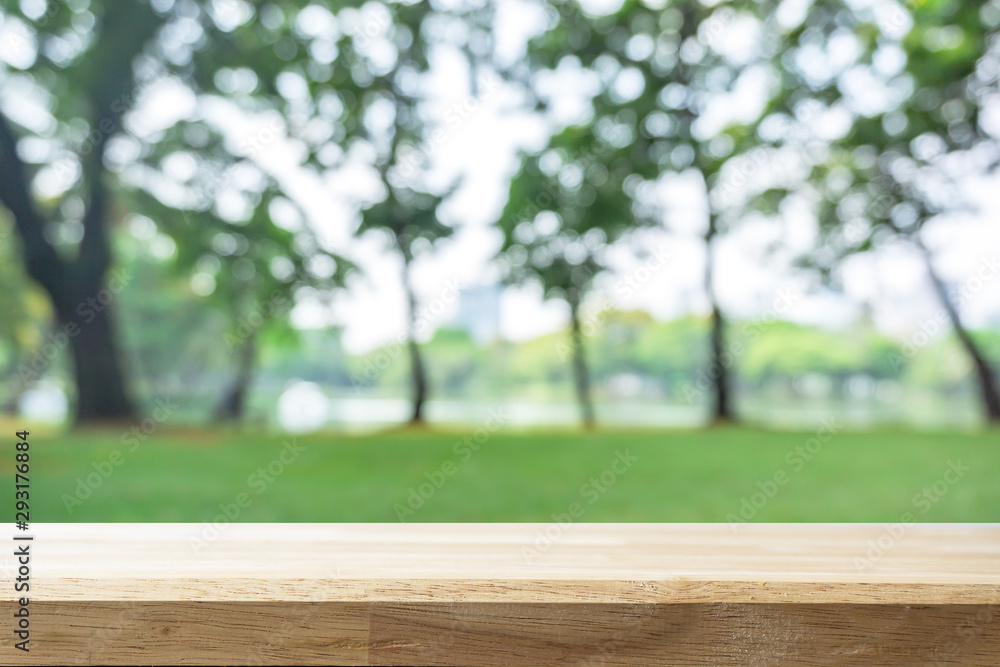 Empty wooden Brown table and blurred garden bokeh background. Mock up for display or montage of product,Business presentation. Empty wooden Brown table and blurred garden bokeh background. Mock up for display or montage of product,Business presentation.