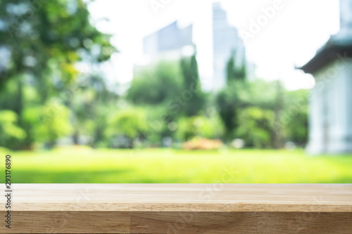 Empty wooden Brown table and blurred garden bokeh background. Mock up for display or montage of product Business presentation.