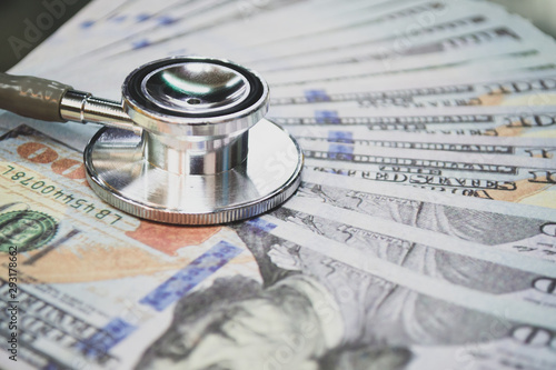 medical cost rising, stethoscope on dollar banknote money. concept of health care costs, finance, health insurance funds. 