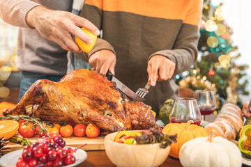 Roasted  chicken or turkey with sauce and grilled autumn vegetables: corn,pumpkin  on wooden table, top view, frame. Christmas or Thanksgiving Day food concept.