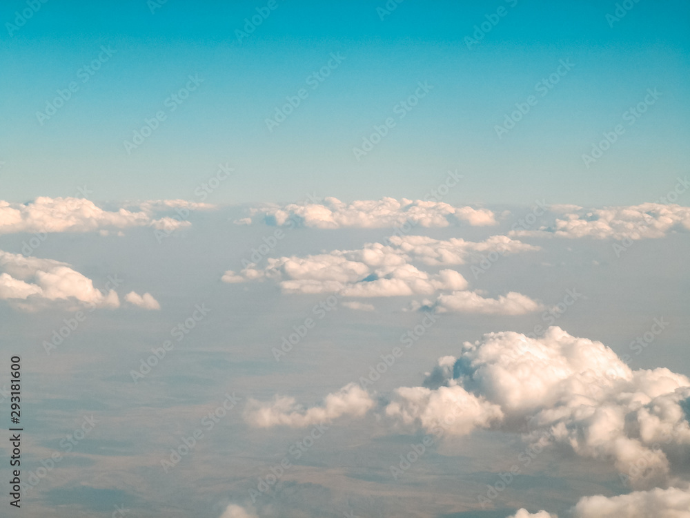 aerial view of the clouds from above through the airplane window