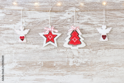 Christmas background - wooden rustic christmas ornament hanging on white wood, lights and copy space design