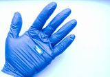 The doctor holds medicines, pills, pills, omega-3 vitamins, capsules with fish oil, a hand in blue gloves. Drug combination therapy for diseases. Capsules on a researcher's hand with a blue glove.