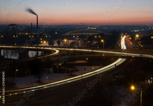Evening sub-urban scene with the busy intersection, bridge and river
