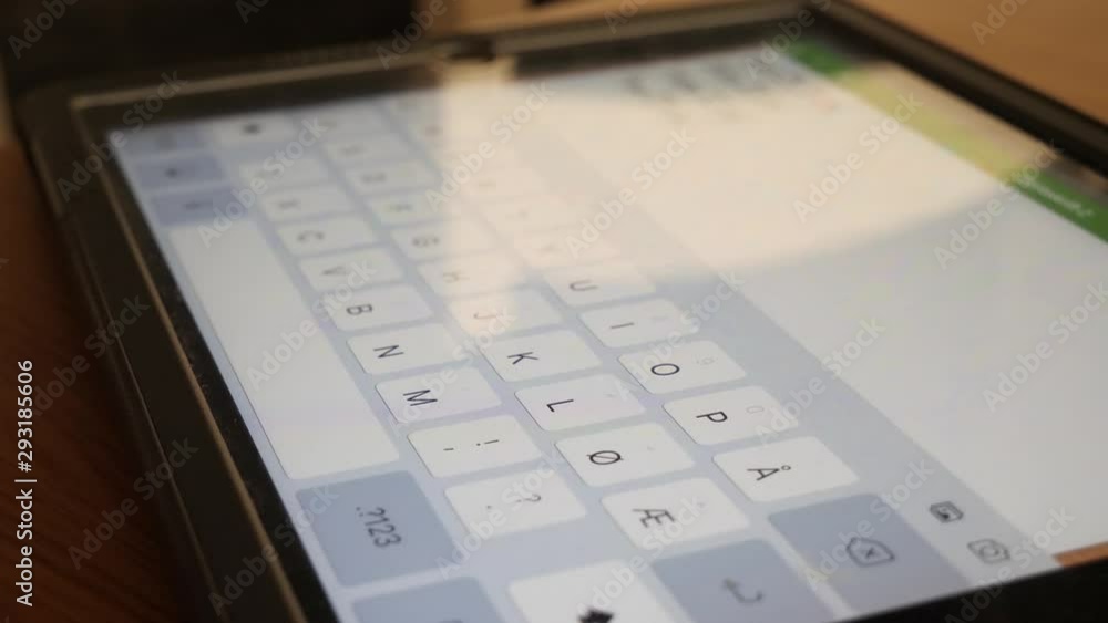 Child's hand typing on a smart tablet - close up