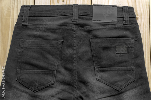 Black clothes label on clothes background, clothes with label tag, Black blank label on background,can used for display or montage your products, and your good for background.