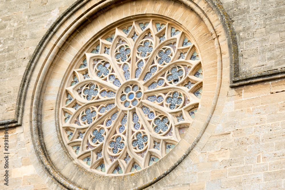 Alcudia. Rosette on the wall of the Catholic Church