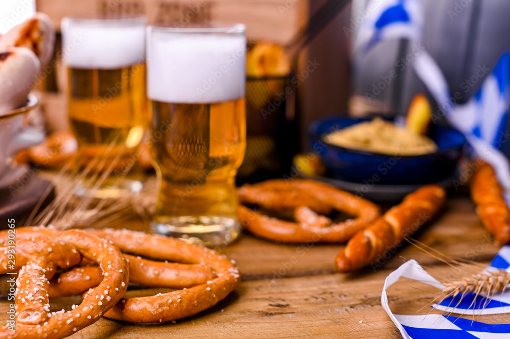 Fresh beer with foam on a wooden background. Oktoberfest German Pretzels Fresh beer with foam on a wooden background. Oktoberfest German Pretzels