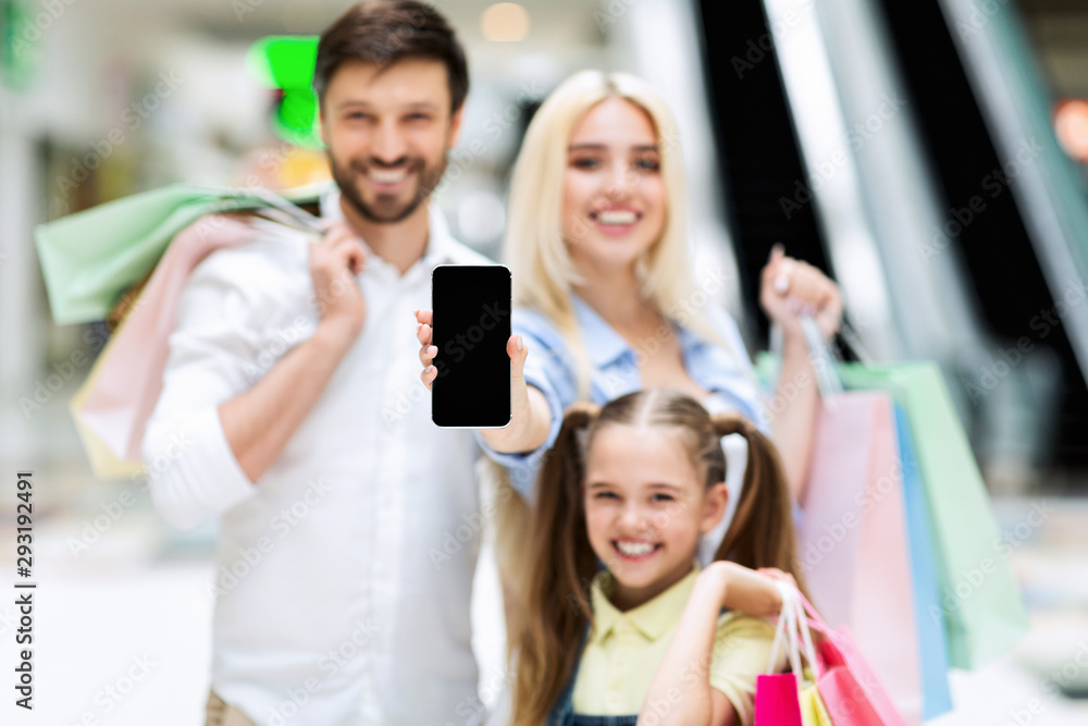 Family Showing Empty Cellphone Screen Standing In Mall, Mockup Family Showing Empty Cellphone Screen Standing In Mall, Mockup