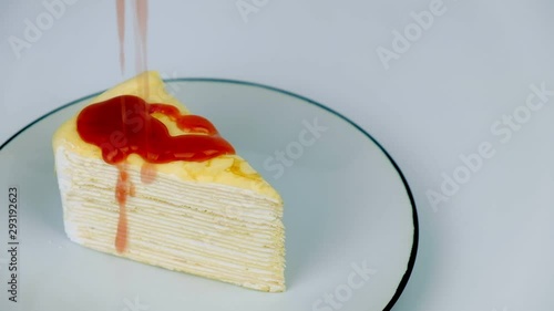 Pour strawberry sauce on crepe cake