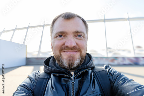 Selfie portrait middle aged man with a beard. Taking photos of yourself on a smartphone.