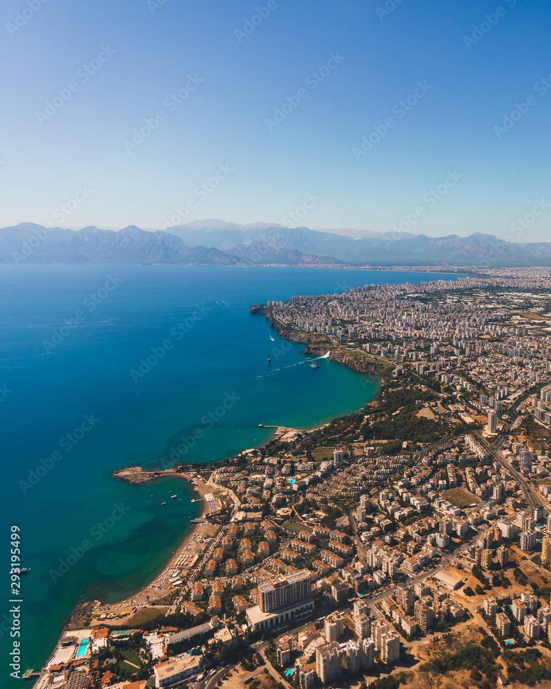 Obraz premium Window view of an airplane on the coast of Antalya with beautiful Taurus Mountains on the horizon, Turkey