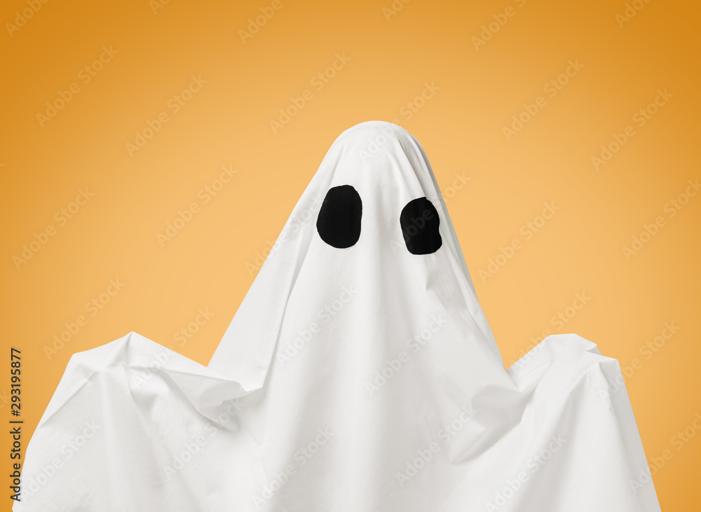 White ghost with black eyes on yellow background.