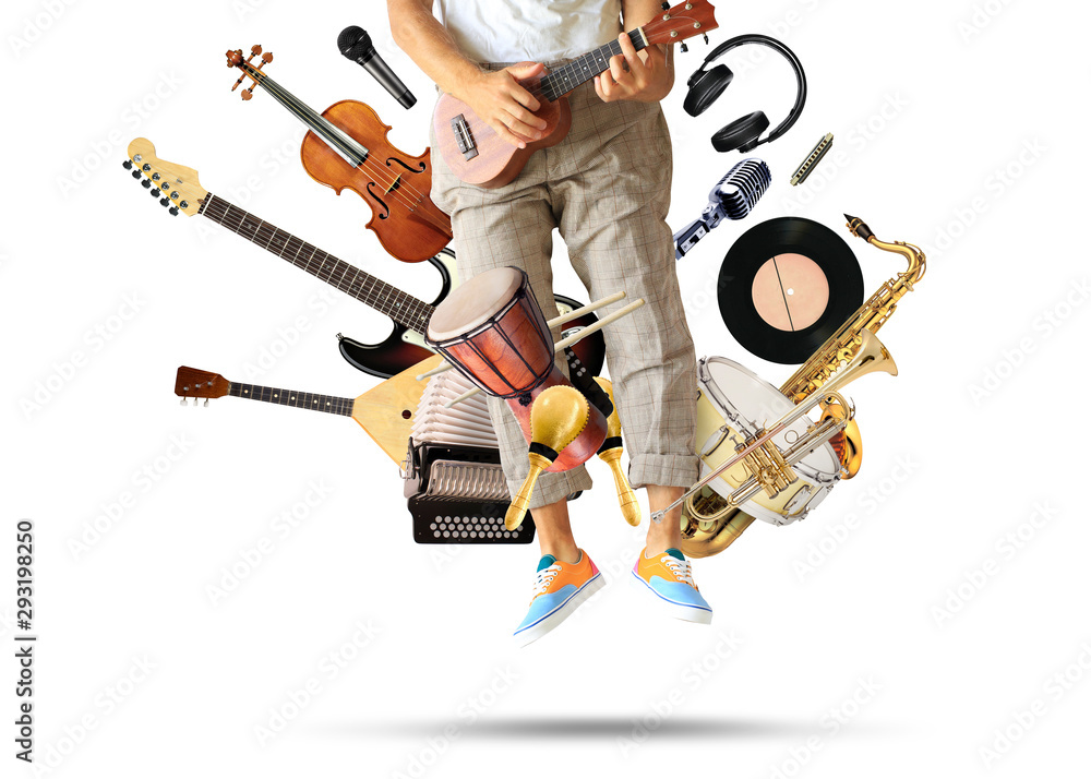 Young man plays guitar among musical instruments Young man plays guitar among musical instruments