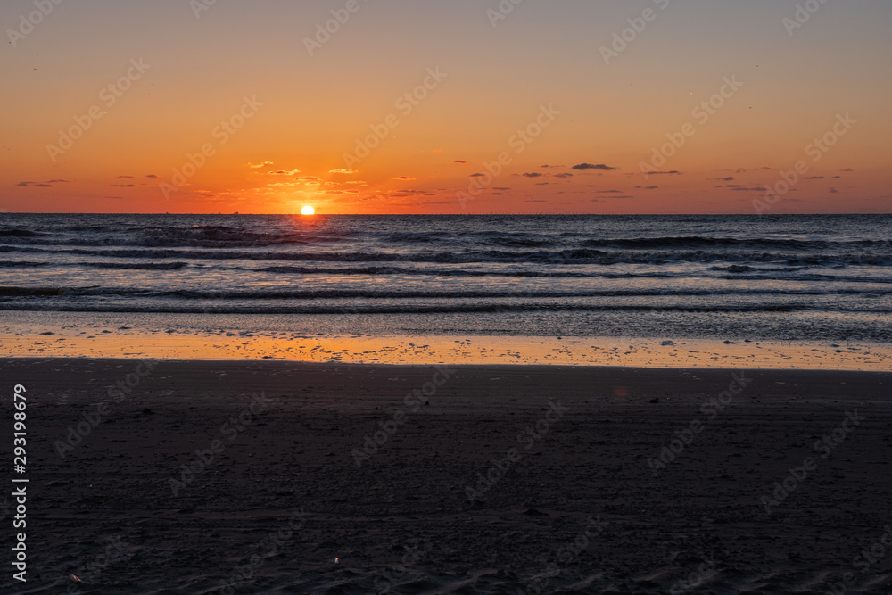 Beautiful sunset landscape at the North sea and orange sky above it with awesome sun golden reflection on waves as a background. Amazing summer sunset view on the beach. Beautiful sunset landscape at the North sea and orange sky above it with awesome sun golden reflection on waves as a background. Amazing summer sunset view on the beach.